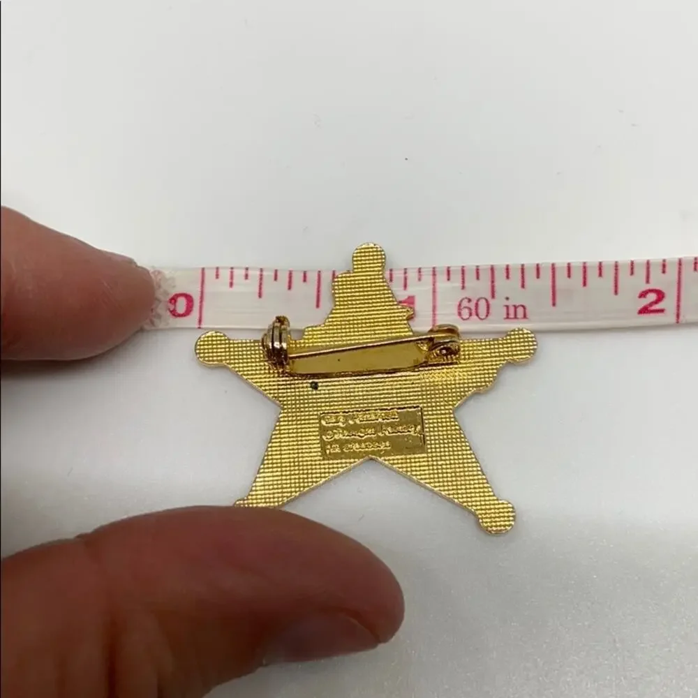 A cowboy on a Rockinghorse sheriff star pin